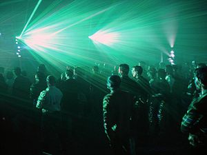 An audience watches a laser light show during ... An audience watches a laser light show during ...